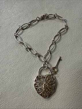 Tiffany & Co. sterling silver filigree heart key lock charm bracelet. 8”
